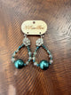 A Rare Bird teal beaded teardrop earrings with large lustrous teal beads and sparkling floral tops