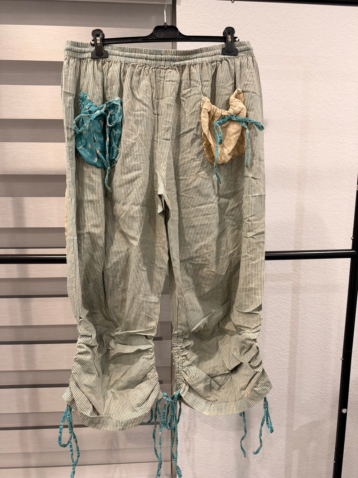 A Rare Bird women's turquoise star and striped patchwork pants with tie hems, back view