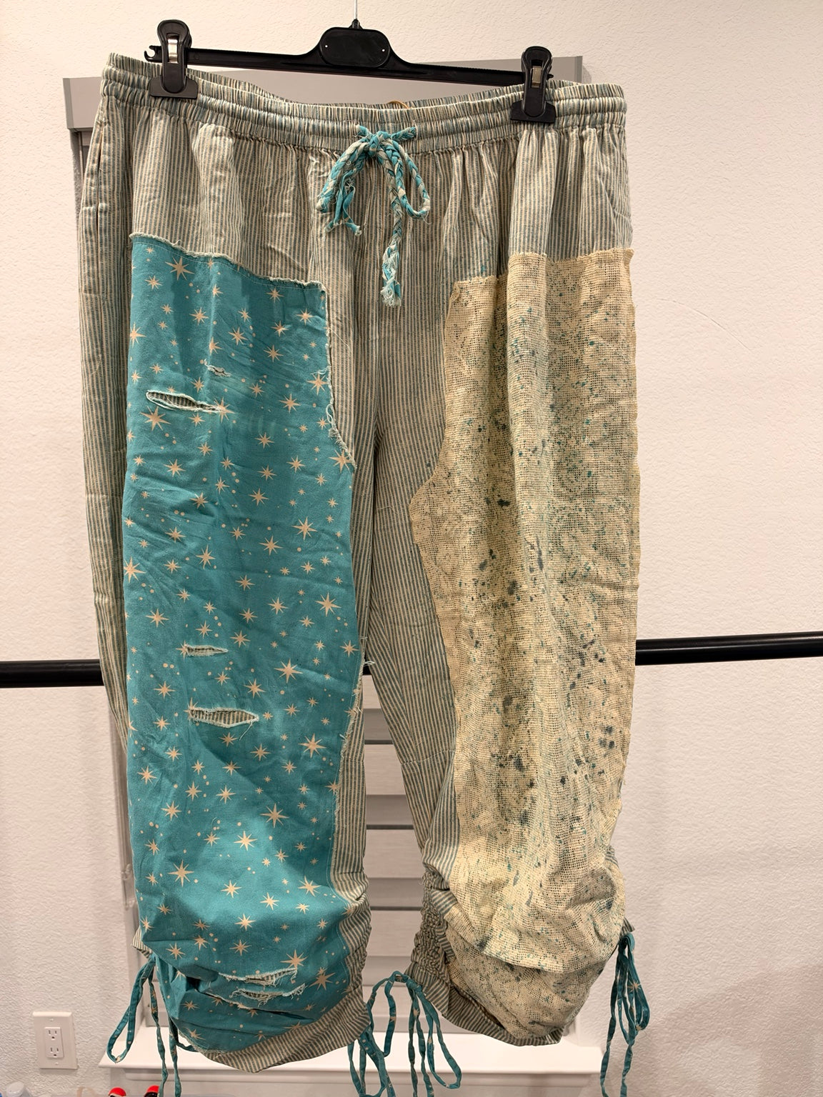 A Rare Bird women's turquoise star and striped patchwork pants with tie hems, front view