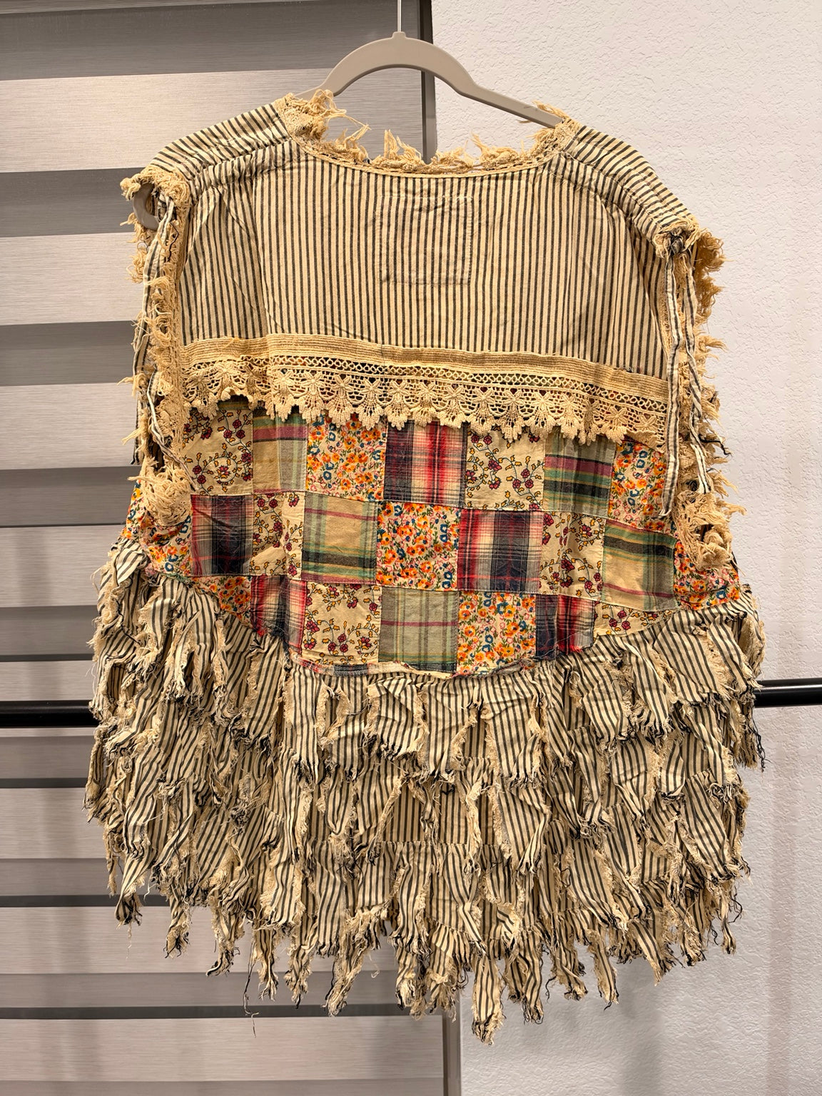 A Rare Bird striped patchwork vest with floral and plaid panels, frayed fringe, and front ties, back view