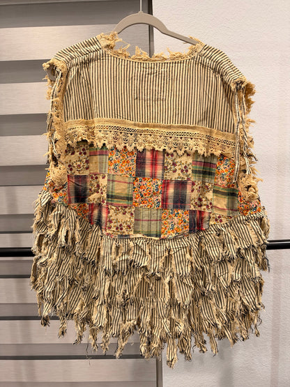 A Rare Bird striped patchwork vest with floral and plaid panels, frayed fringe, and front ties, back view