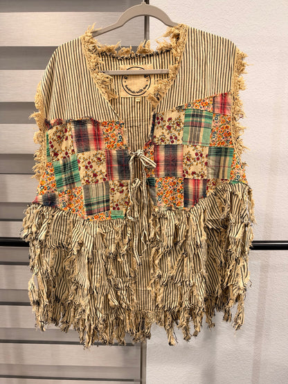 A Rare Bird striped patchwork vest with floral and plaid panels, frayed fringe, and front ties, front view