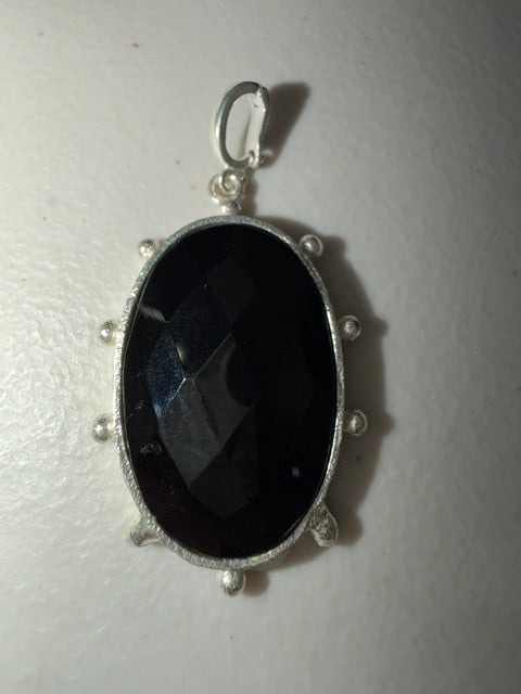WaFa Black Onyx Medallion Pendant — large faceted oval black onyx in textured silver-tone bezel with dot border