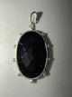 WaFa Black Onyx Medallion Pendant — large faceted oval black onyx in textured silver-tone bezel with dot border