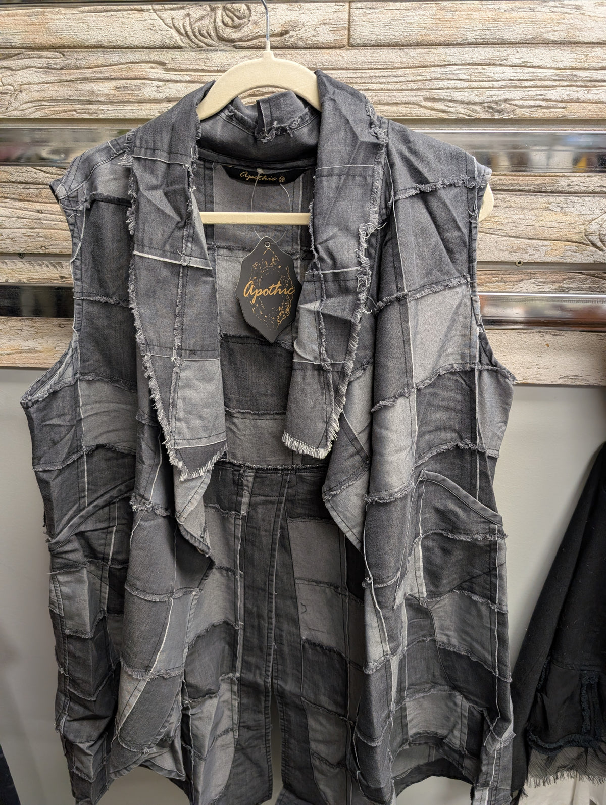 Apothic Grey Patch sleeveless vest with draped open front, frayed patchwork seams and front pockets