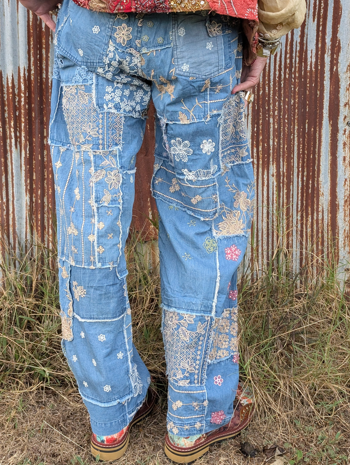 Bluebird Reverie Patchwork Pants — Felecia Bella by paper lace, back view showing blue patchwork panels, floral embroidery and frayed seam details, with back patch pockets.