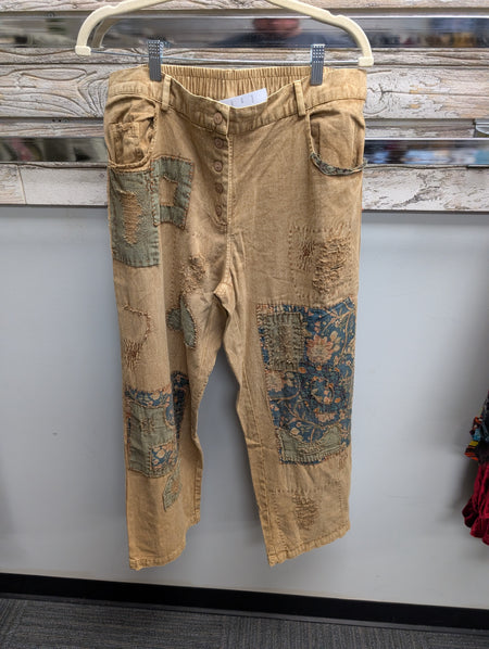 Front of Paper Lace Khaki patchwork pants with floral panels and distressed details
