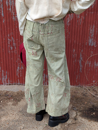 Back view of the Gilded Wishes Holiday Pants sample, showing patterned fabric, patch pockets and a gathered back waistband. Sample photo; finished ribbon will include gold thread and crystals.