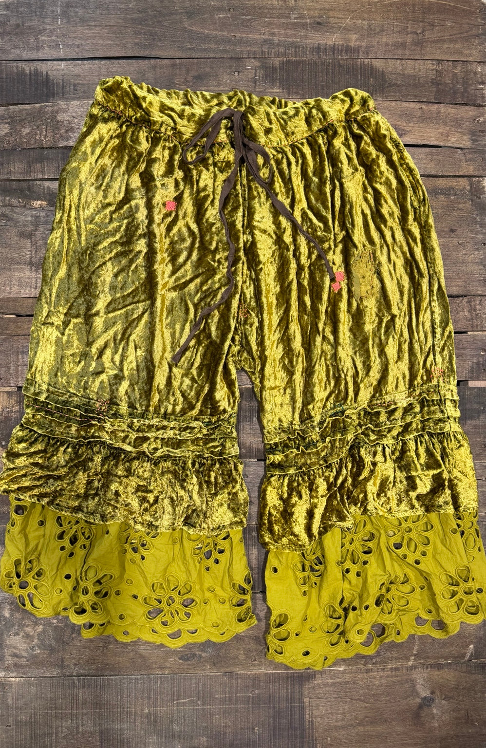 House of Jaded Gypsy chartreuse velvet-look pants with ruffles and floral eyelet hems, front