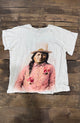 House of Jaded Gypsy white graphic tee, front with portrait in a pink floral shirt and hat