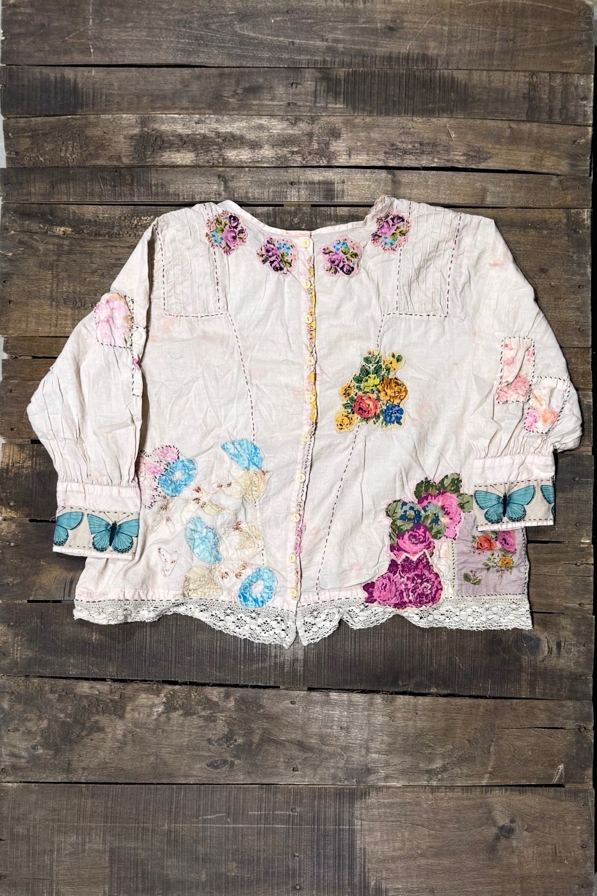 Buttoned back of House of Jaded Gypsy Gilded Bloom Top Flutter with floral patchwork details, butterfly cuffs and lace trim
