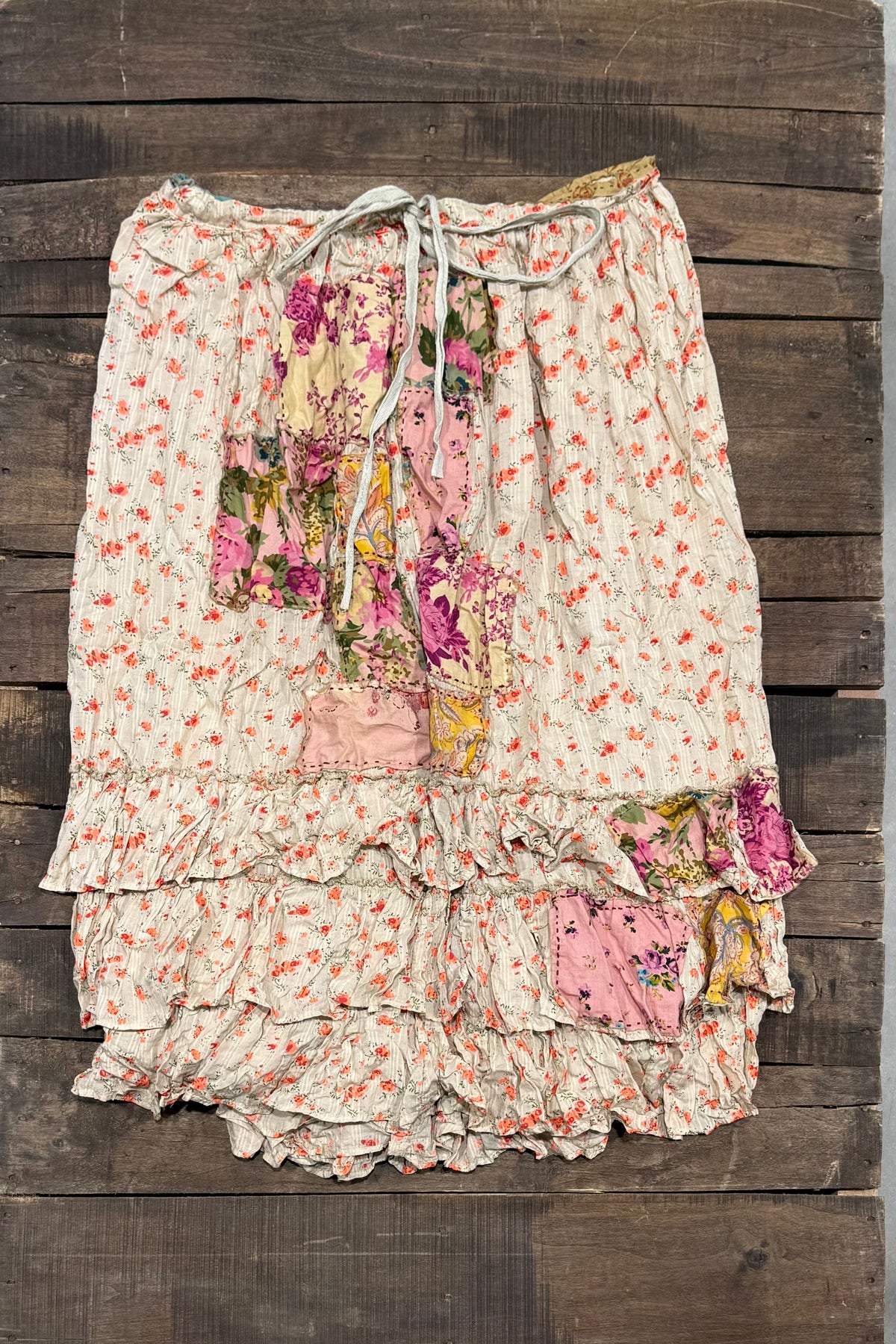 House of Jaded Gypsy Sun Spell Skirt in Canyon Glow, front with small floral print, colorful patchwork, waist tie and tiered ruffles