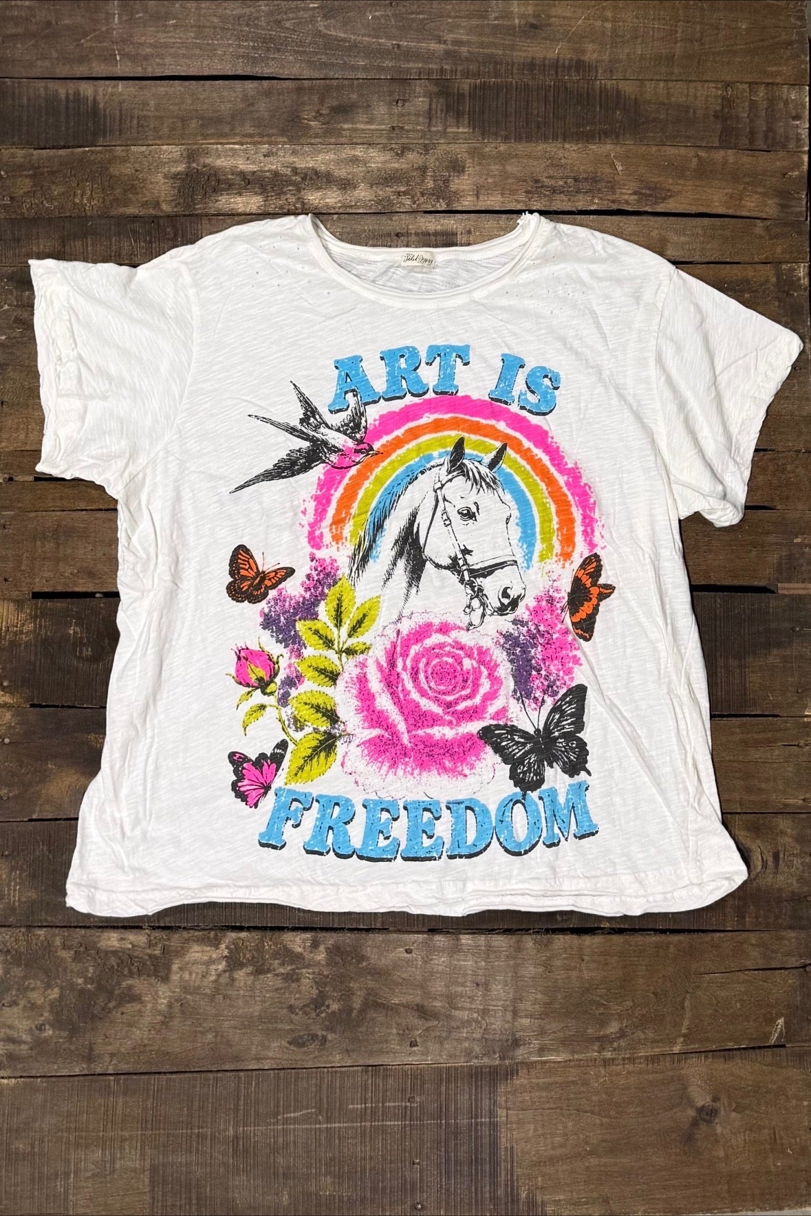 House of Jaded Gypsy Weathered and Worn Tee Derby, white graphic tee with Art Is Freedom lettering, horse, rainbow, roses and butterflies