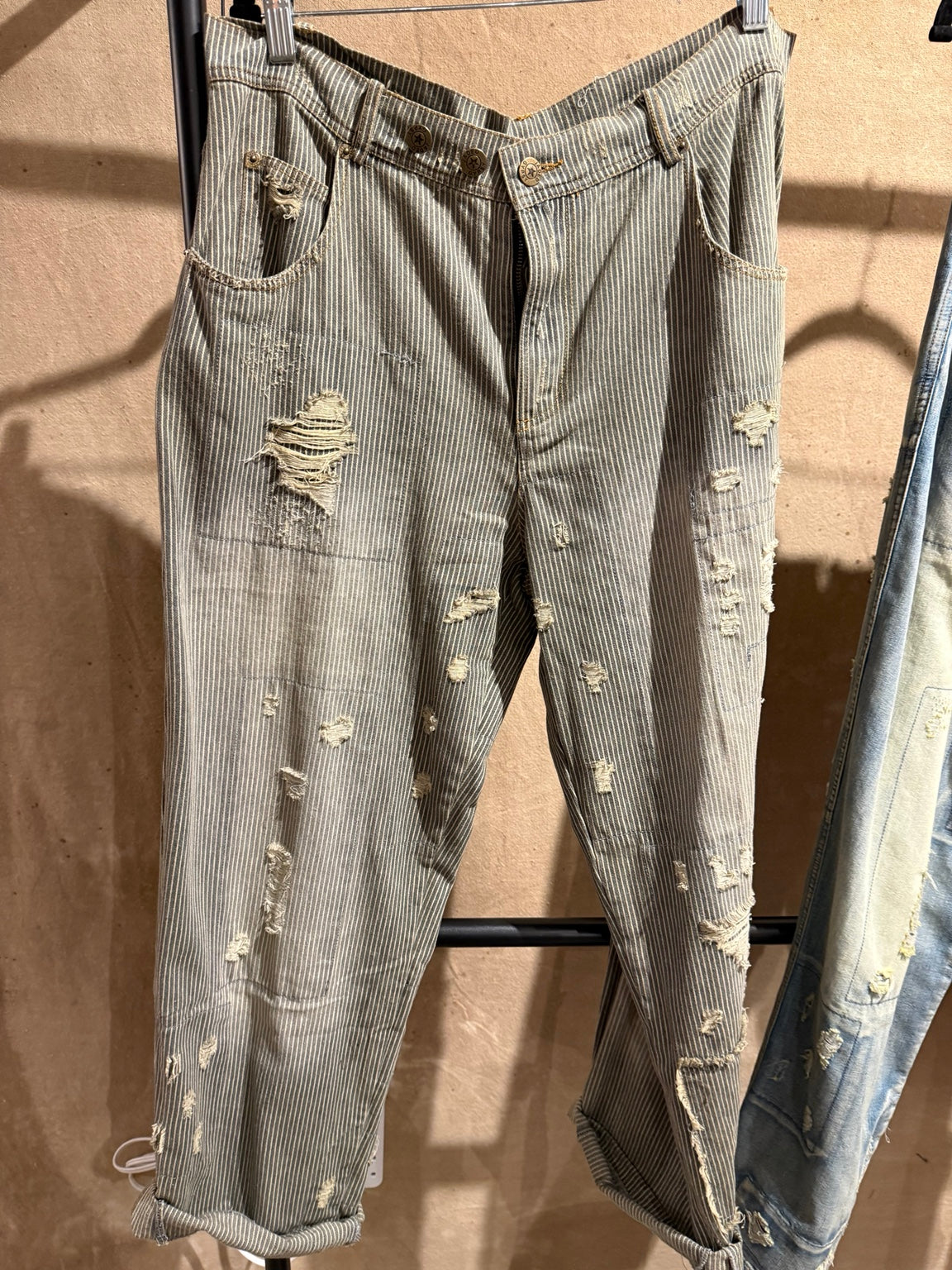 Jaded Gypsy Peace and Love Jeans in Midnight Railroad with narrow stripes, distressed patches and rolled cuffs
