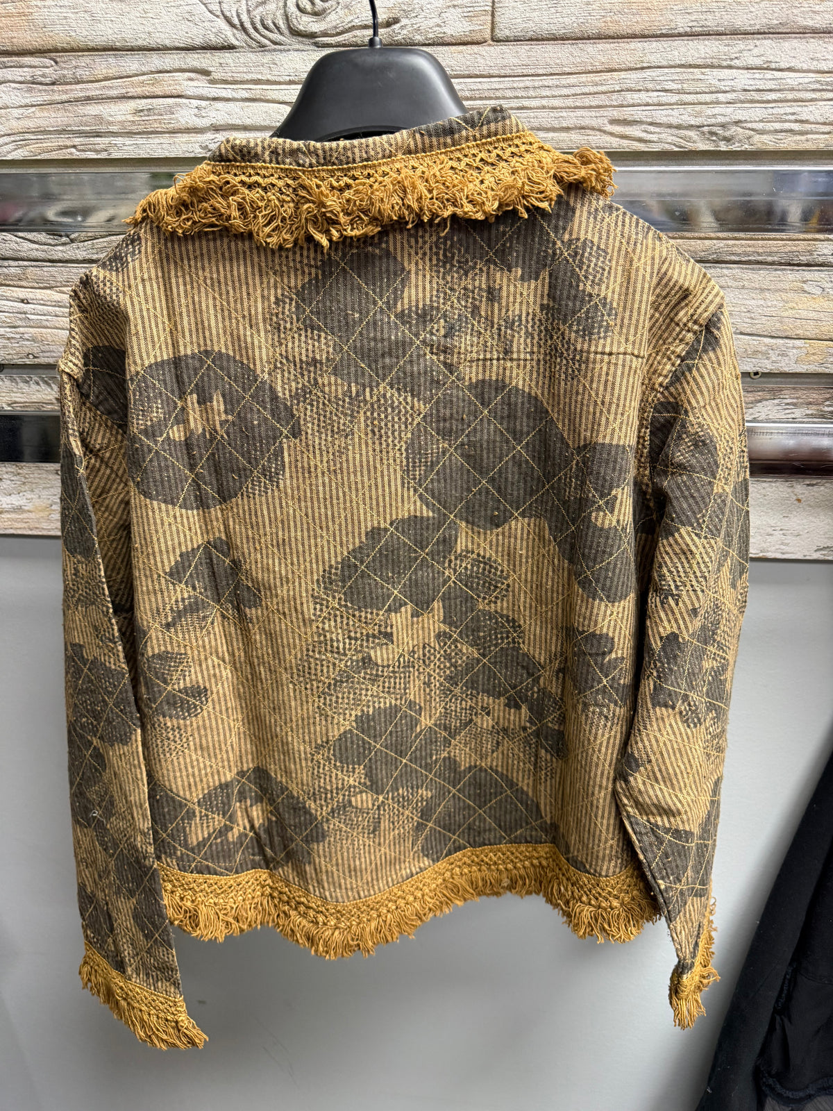 Back of Paper Lace mustard jacket with dark peace signs, diamond quilting and fringe hem
