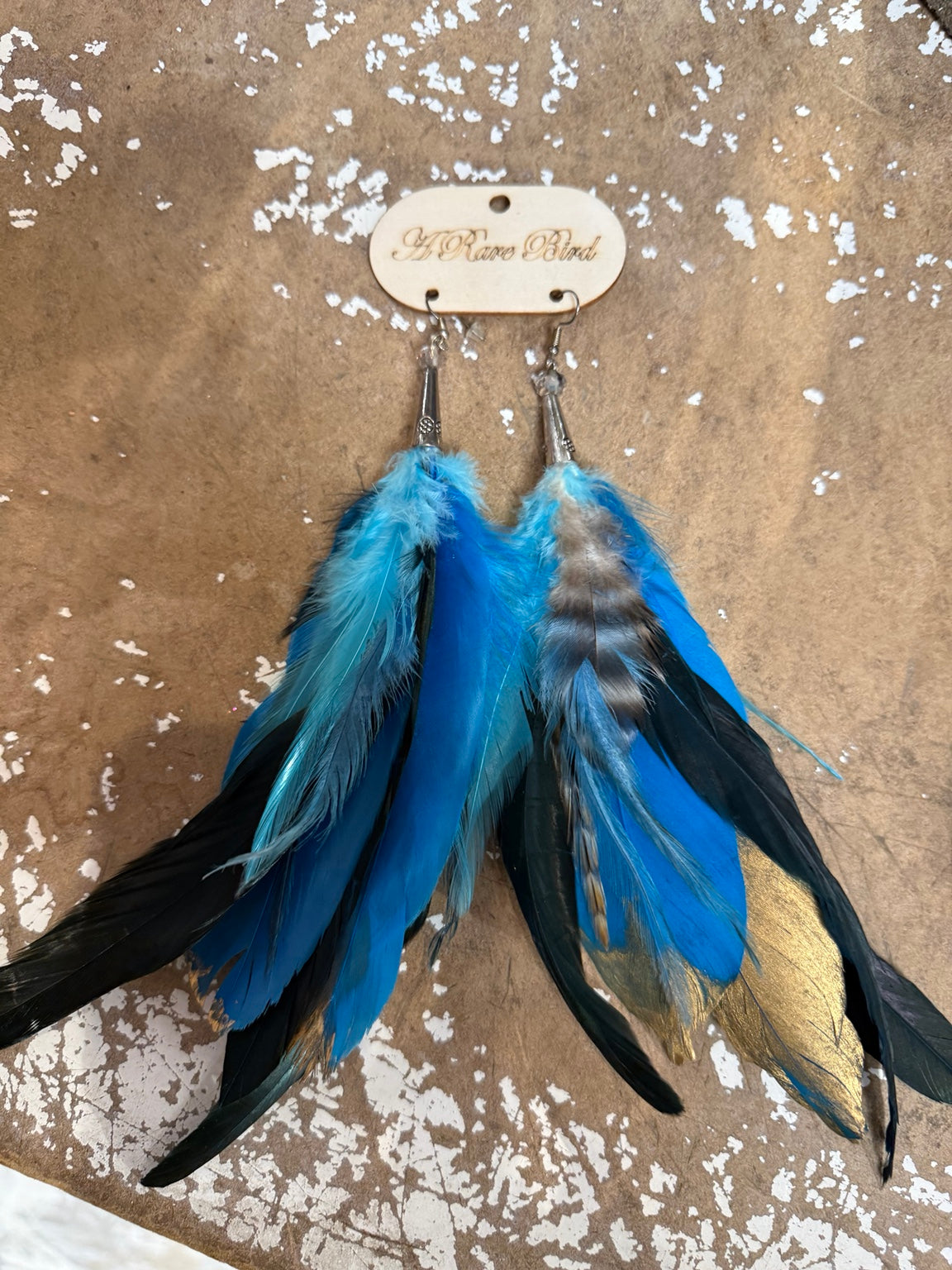 A Rare Bird Blue Moon Flight feather earrings in blue, turquoise and black with gold accents