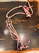 A Rare Bird pink beaded peace sign necklace with pink tassels and silver tone accents