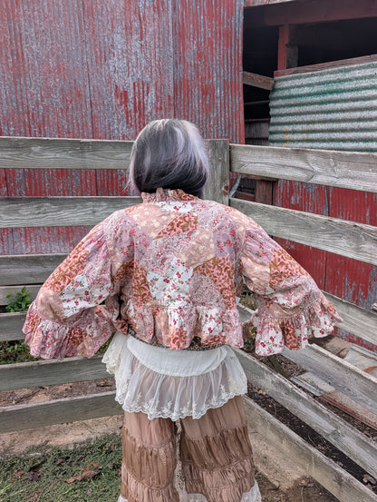 Back view of the reverse side of Rosewater Rhapsody Reversible Jacket — Felecia Bella by paper lace, showing pink and cream floral and paisley patchwork.