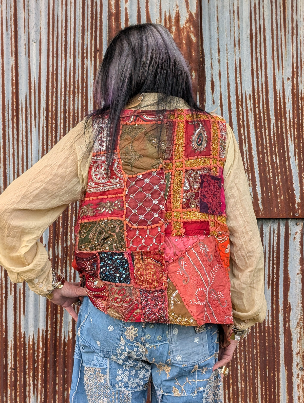 Back view of the Scarlet Caravan Patchwork Vest — Felecia Bella by paper lace, showing multicolored embellished patchwork panels.