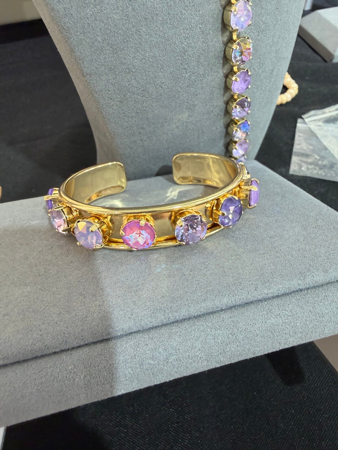 Gold-tone open cuff with round pink, lavender and iridescent crystals