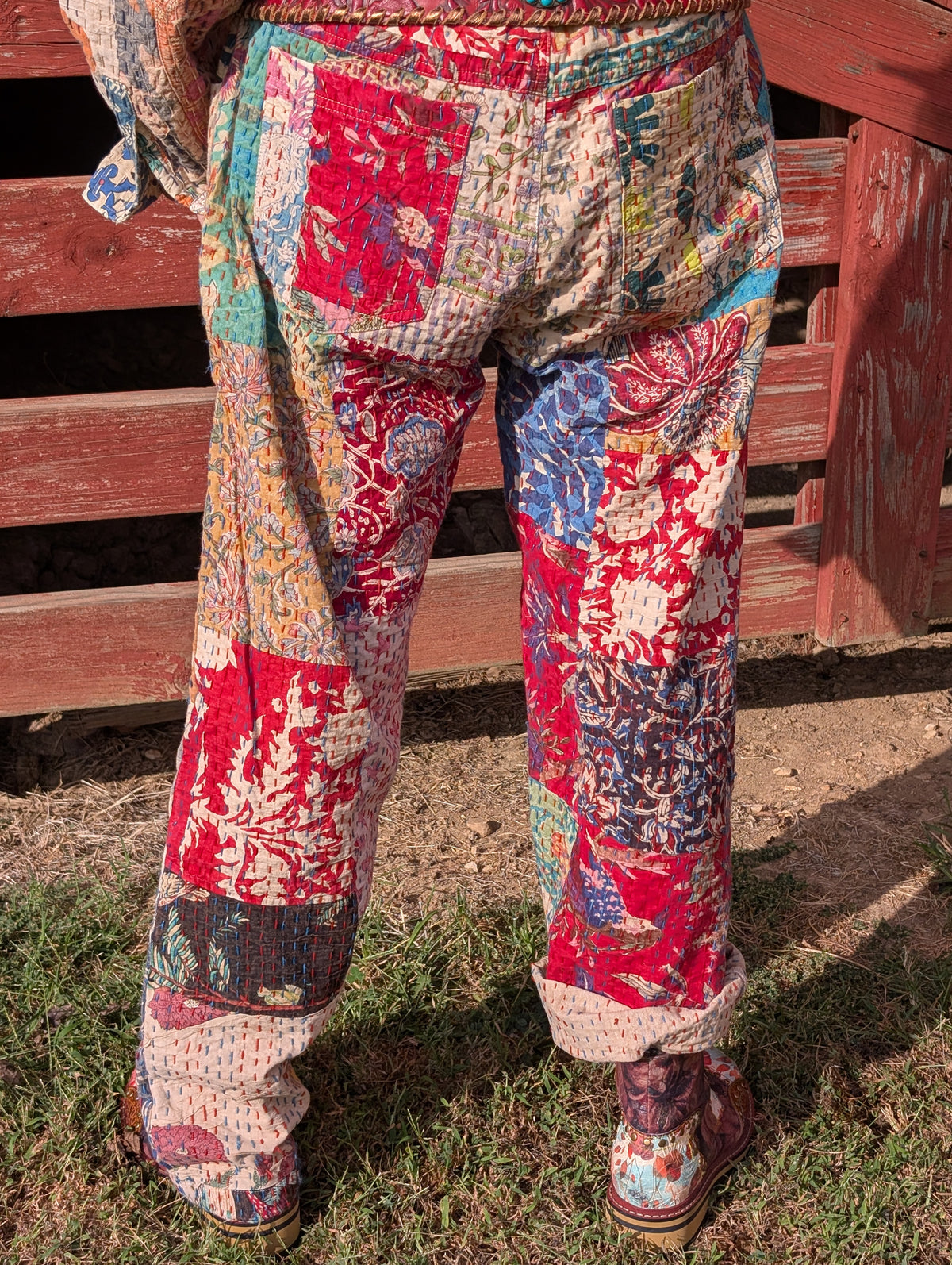 Wandering Soul Kantha Pants — Felecia Bella by paper lace, back view showing colorful patchwork and stitched texture, with back patch pockets. Belt and shoes are styling accessories.