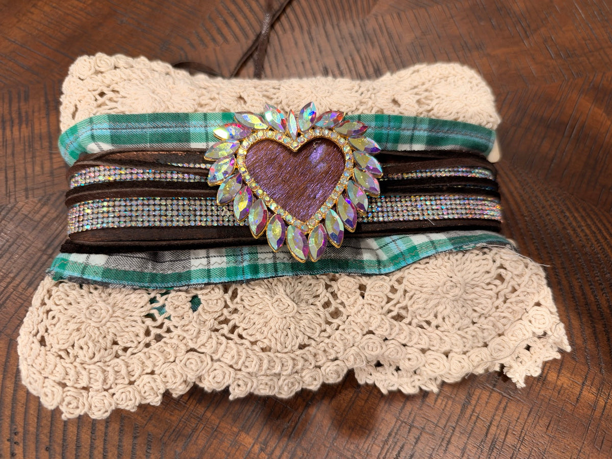 Ivory lace cuff with green plaid, brown bands and an iridescent jeweled heart