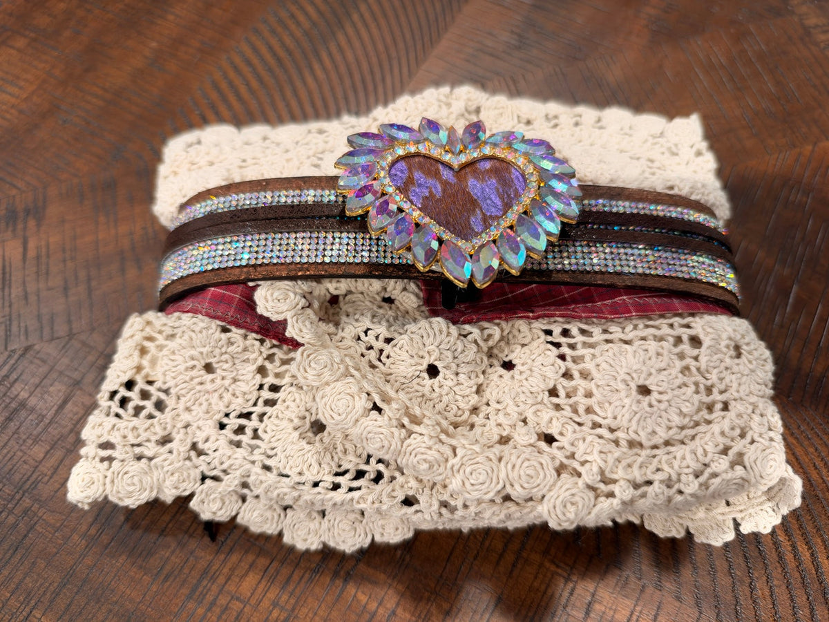 Ivory lace cuff with red plaid, brown bands and a purple-accented jeweled heart
