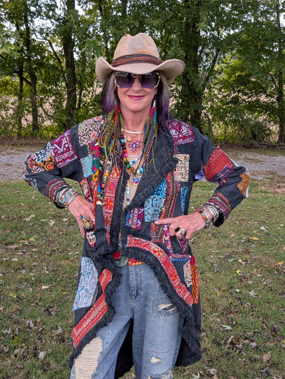 Front styled view of Wild Heart Wanderer Duster — Felecia Bella by paper lace, showing dark fabric, colorful patchwork and a draped fringed front.